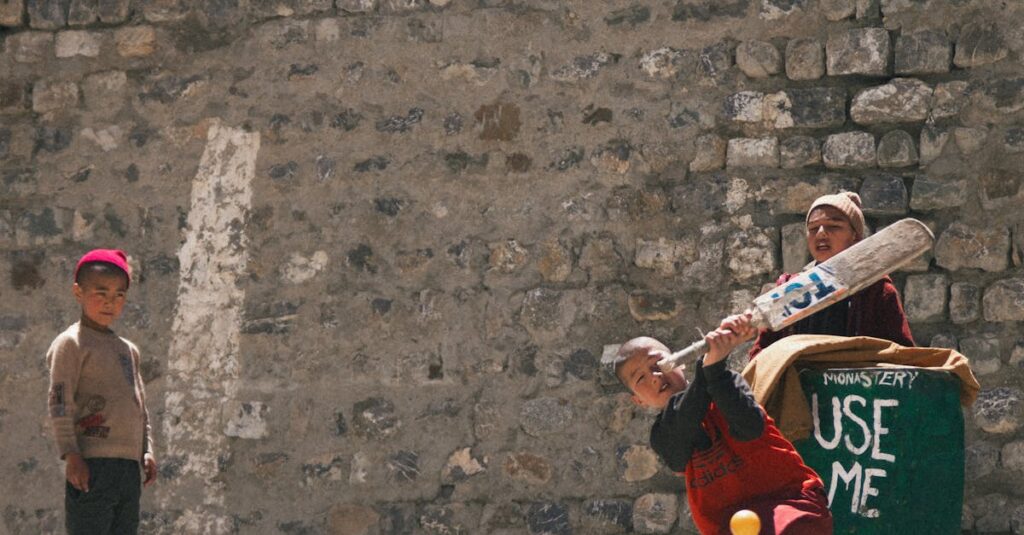 Children enjoy a cricket game in the outdoor setting of Key Village, Himachal Pradesh.