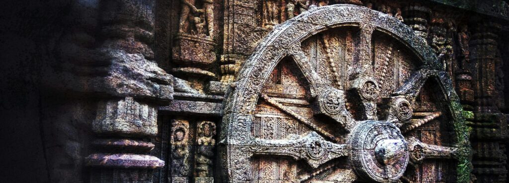 Intricate stone carving of a chariot wheel at the historic Konark Sun Temple, India.